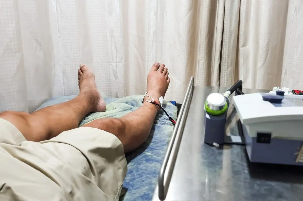 Patient receiving interferential therapy as part of the physiotherapy course to heal injured ankle